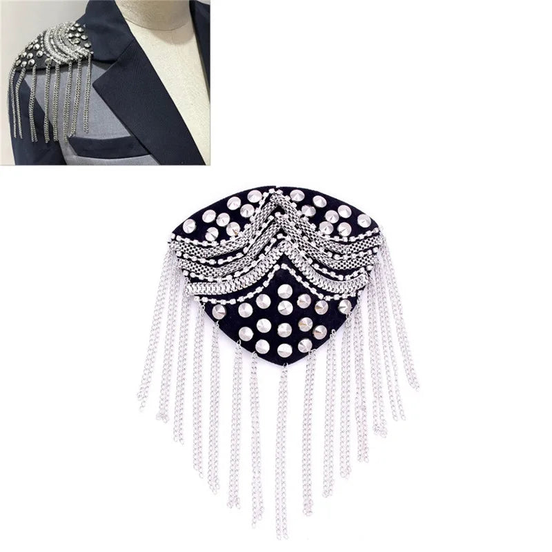 Decorative black embellished tassel brooch accessory on white background