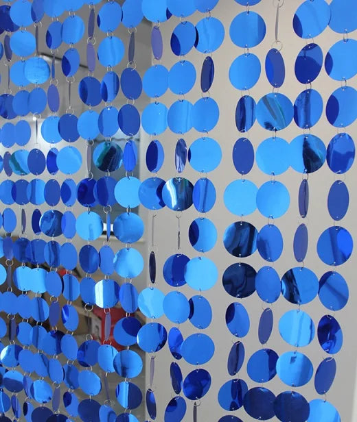 Blue circular disc sequin curtain against a neutral background