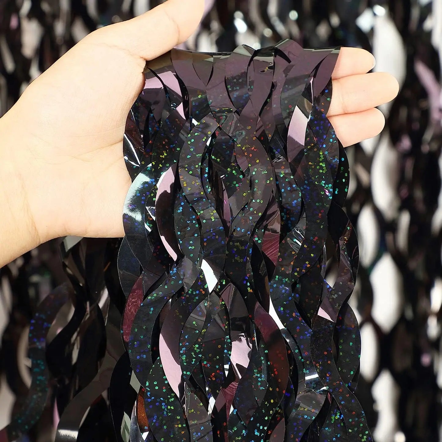 Premium black shimmer fringe curtain material with reflective foil finish for party decorations and event backdrops
