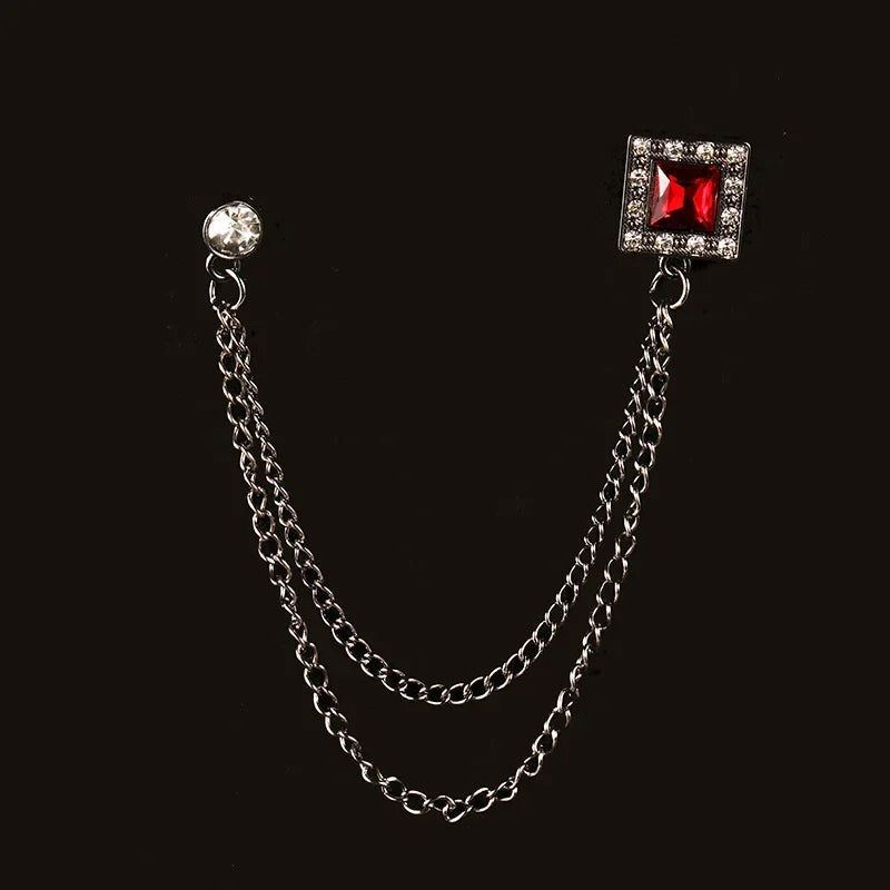 Elegant silver tassel chain brooch with red gemstone detail