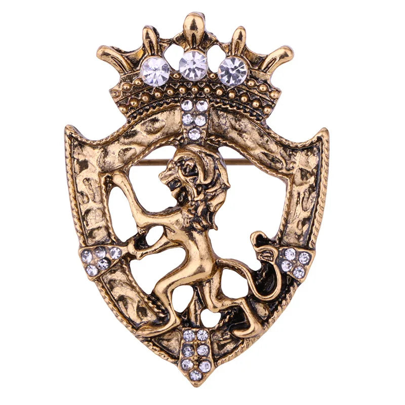 Lion emblem brooch with crown and crystal detailing on white background