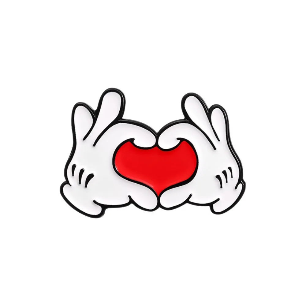 Cartoon hands holding red heart enamel pin on white background