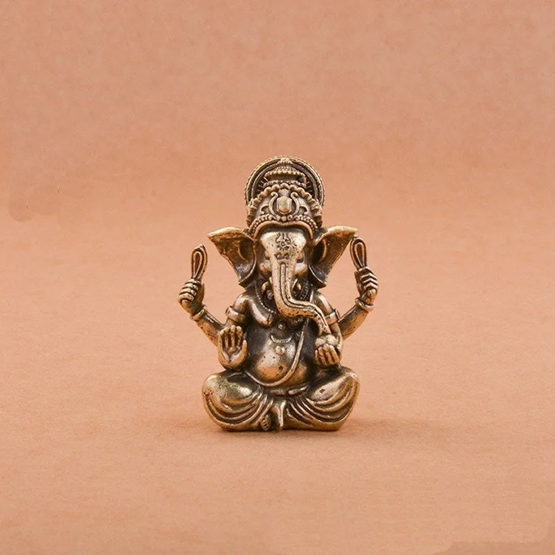 Solid brass Lord Ganesha statue on a beige background