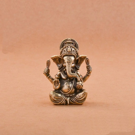 Solid brass Lord Ganesha statue on a beige background
