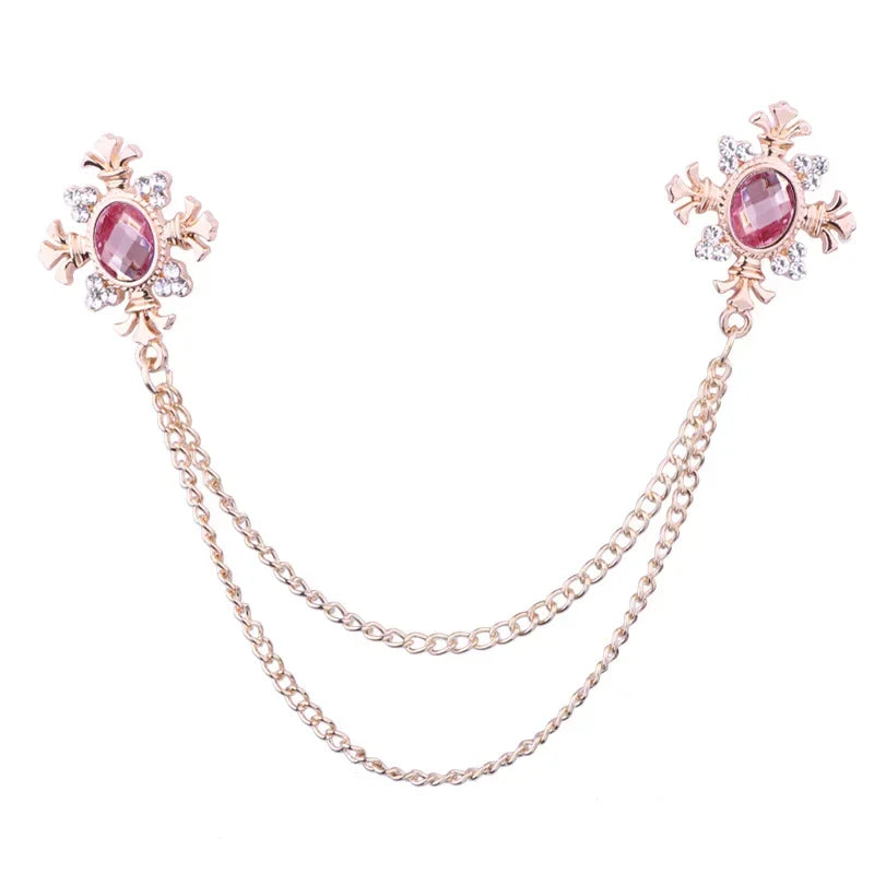 Gold PInk Crystal cross chain brooch pins with gemstone accents on white background.