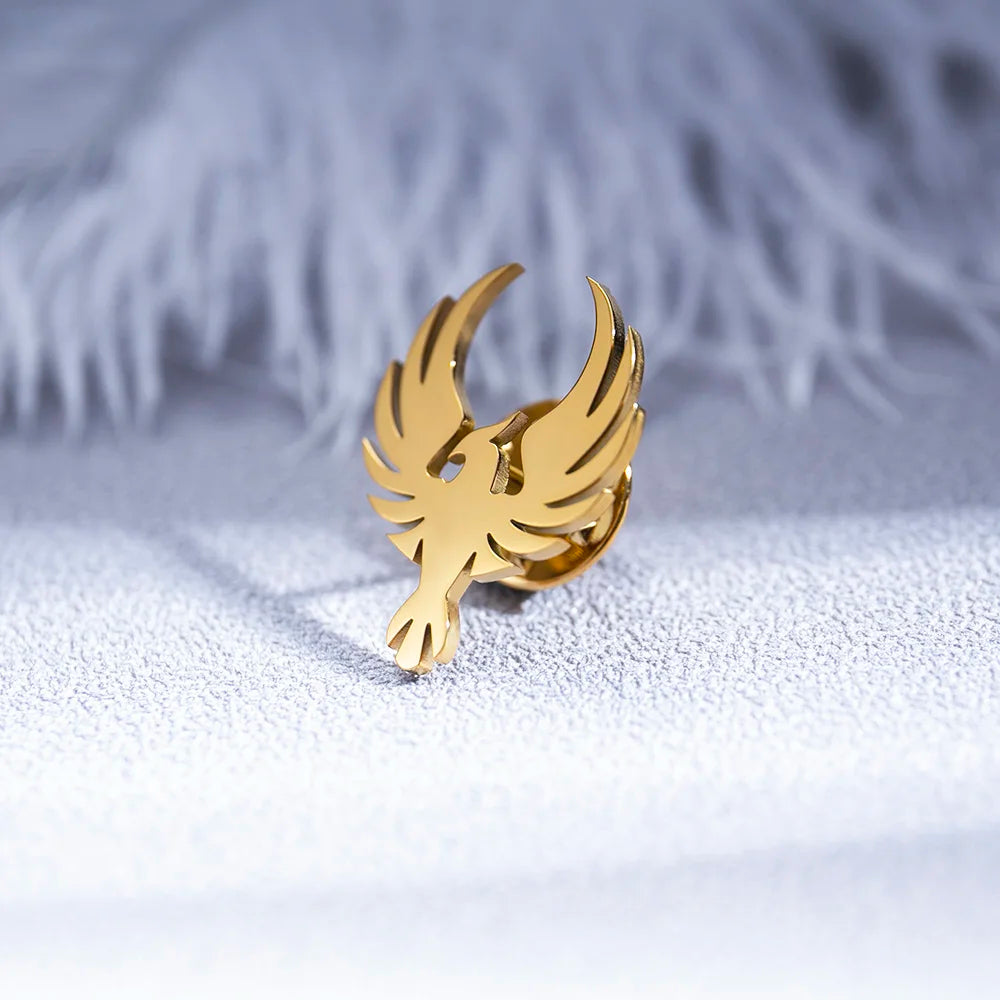 Gold bird shaped earring elegant fashion jewelry on textured white surface