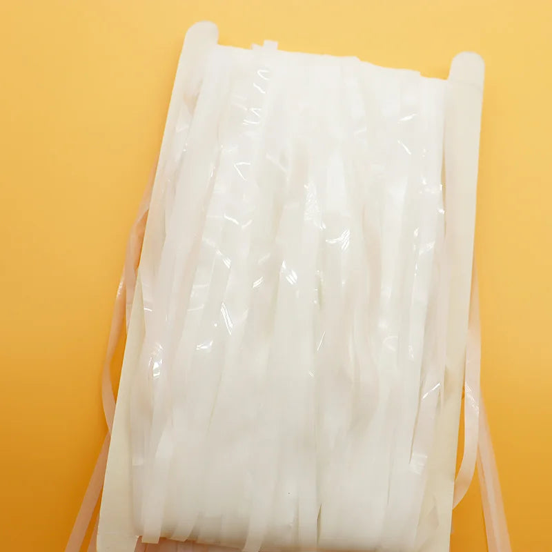 Spool of white thread on a yellow background