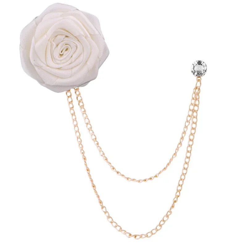 White flower brooch with gold chain on a white background