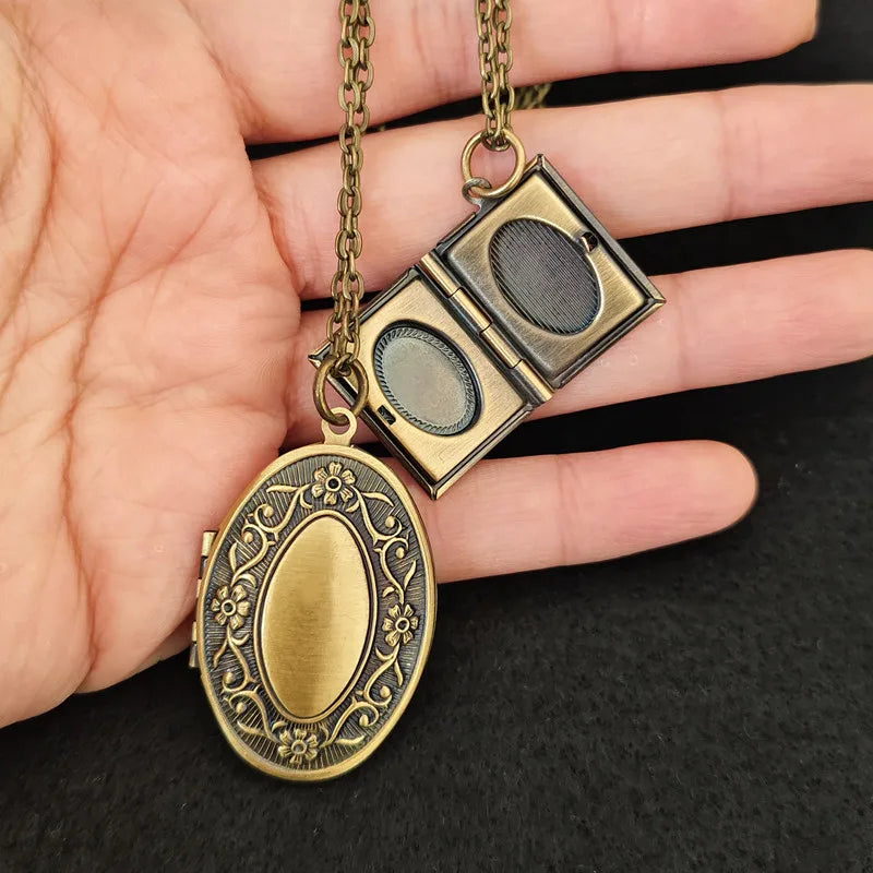 Classic keepsake locket keychain in oval and book style designs show in hand with chain of 60cm