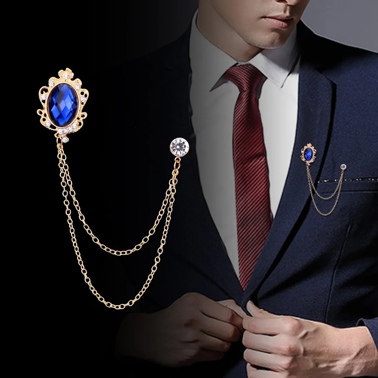 Man wearing a suit with decorative lapel pins featuring blue gemstones and gold chains.