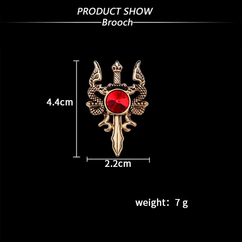 Brooch with red gem and wings, shown with measurements on a black background