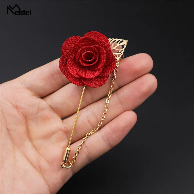 Red rose brooch held in hand close up elegant floral fashion accessory pin
