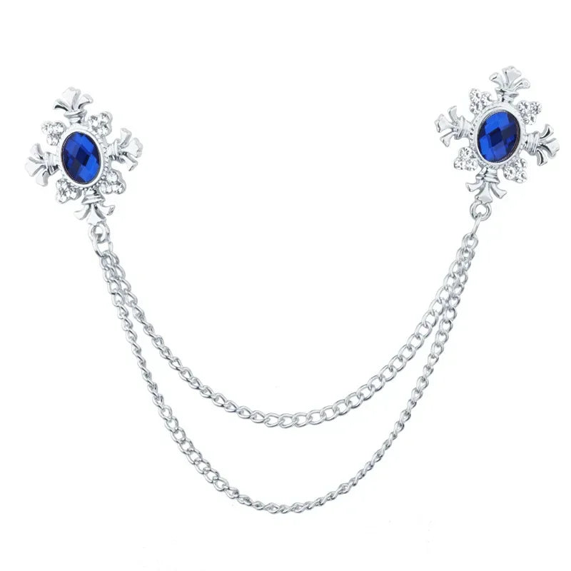 Silver Blue Crystal cross chain brooch pins with gemstone accents on white background.