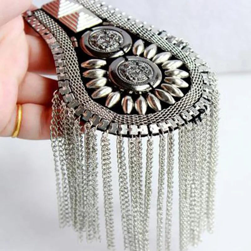 Silver rhinestone brooch with chain tassels held in hand
