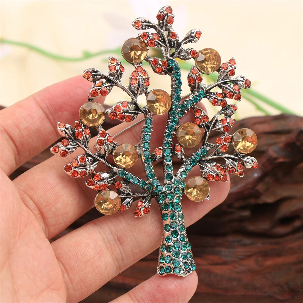 Handmade money tree brooch with colorful rhinestones held in hand