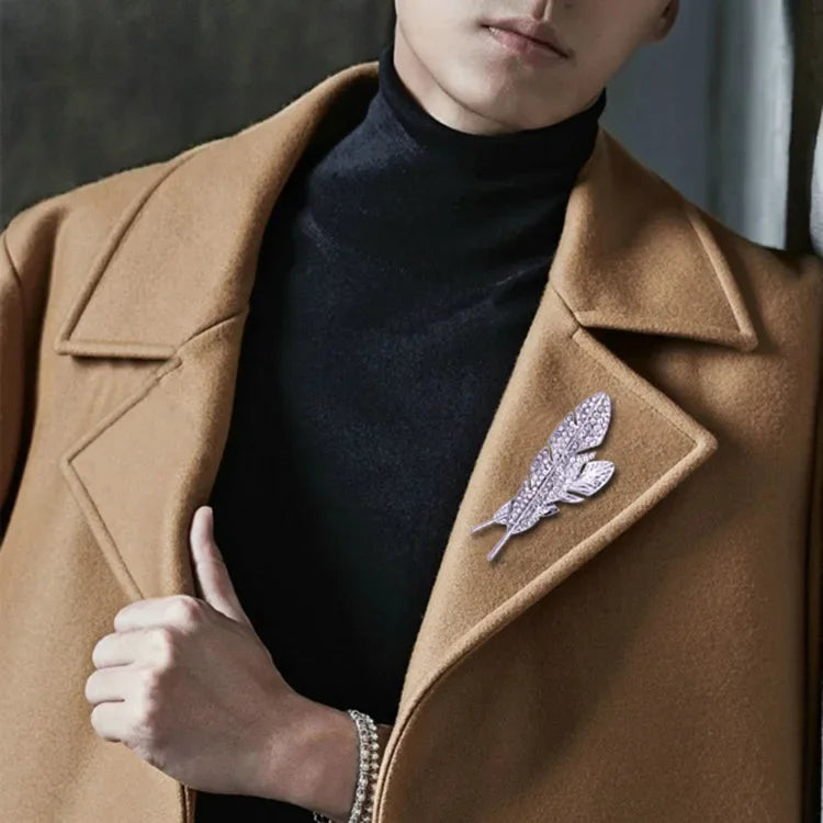 Man wearing brown coat with luxury feather crystal brooch lapel pin for formal suit style