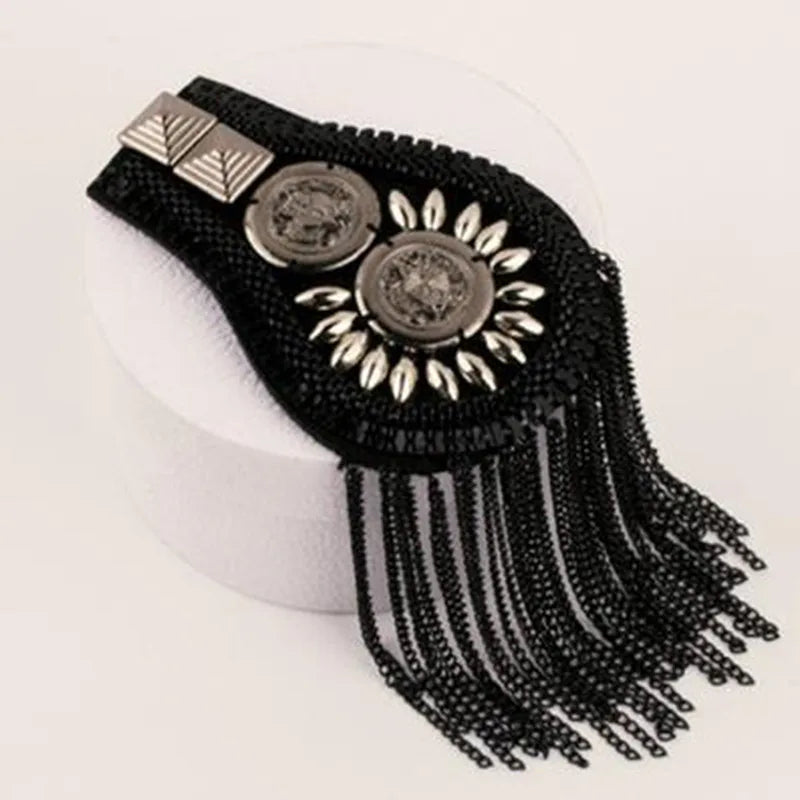 Black beaded shoulder accessory with metallic decorative detailing