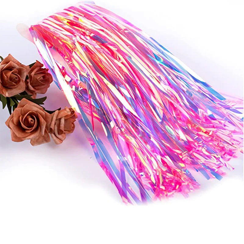 Colorful tinsel on a white background with two brown roses.