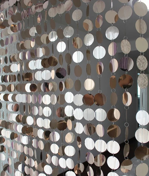 Metallic circular sequin curtain with a reflective surface