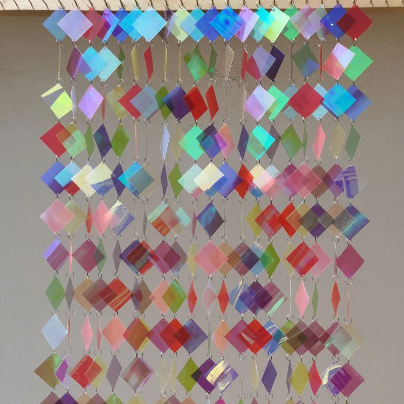 Colorful sequin curtain with diamond pattern on a plain background