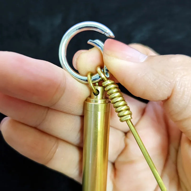 Hand holding premium brass alloy mini tool keychain with portable storage case for everyday carry