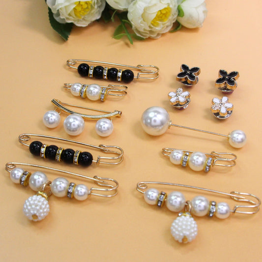 Collection of pearl waist brooch pins on peach background