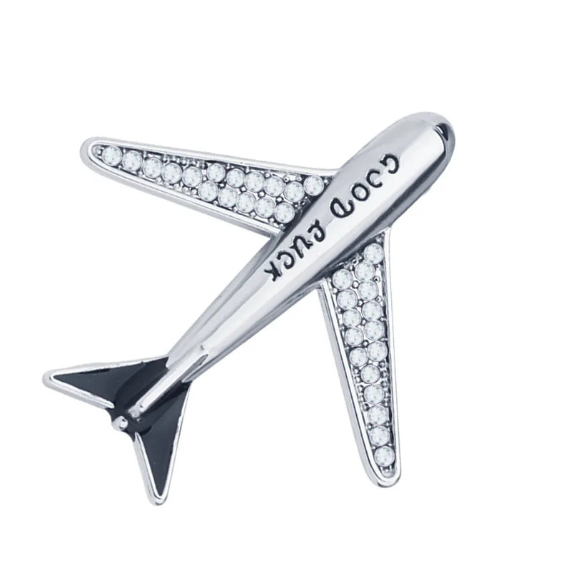 Silver aircraft brooch pin with engraved detailing on white background.