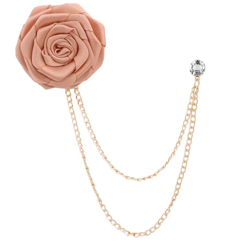 Pink rose flower brooch with gold chain and crystal on a white background