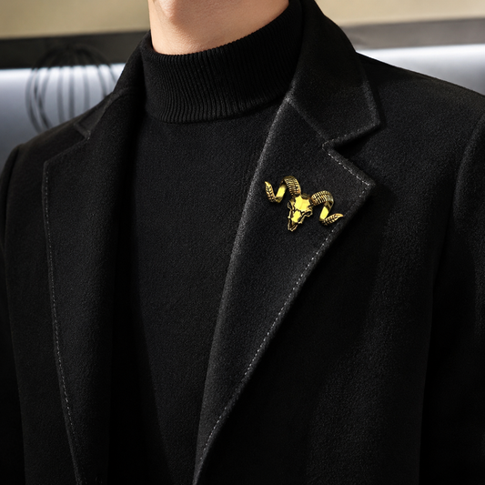 Fashion model wearing a black coat with a ram skull lapel brooch.