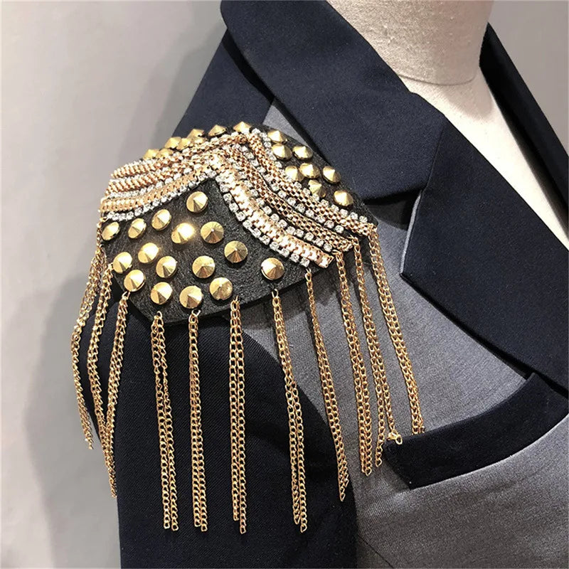 Black blazer with gold fringe shoulder brooch on mannequin