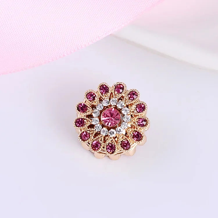 Pink rhinestone floral brooch for hijab and scarf styling on a light pink background