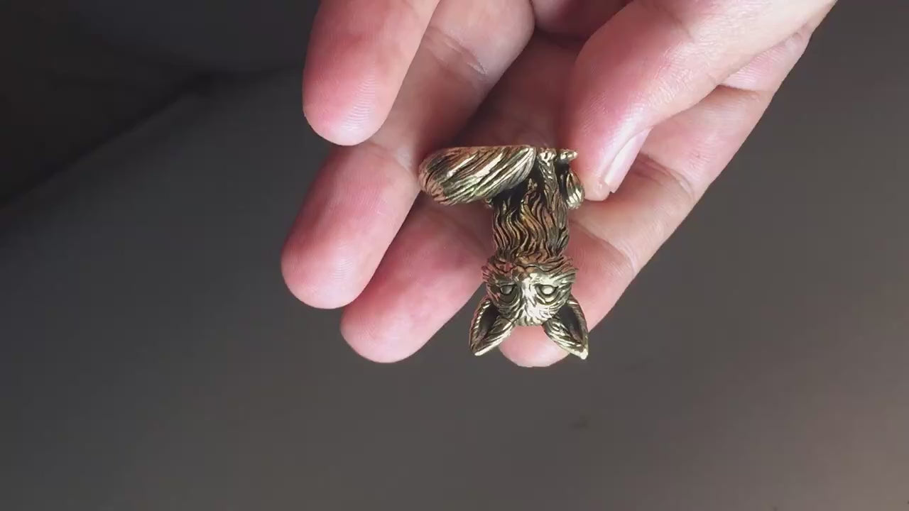 Bronze fox figurine in hand showing in video