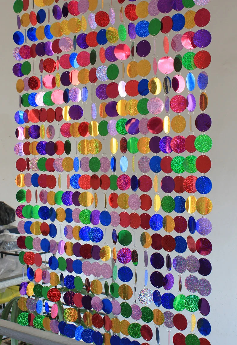 Multicolored circular sequin curtain on a white background