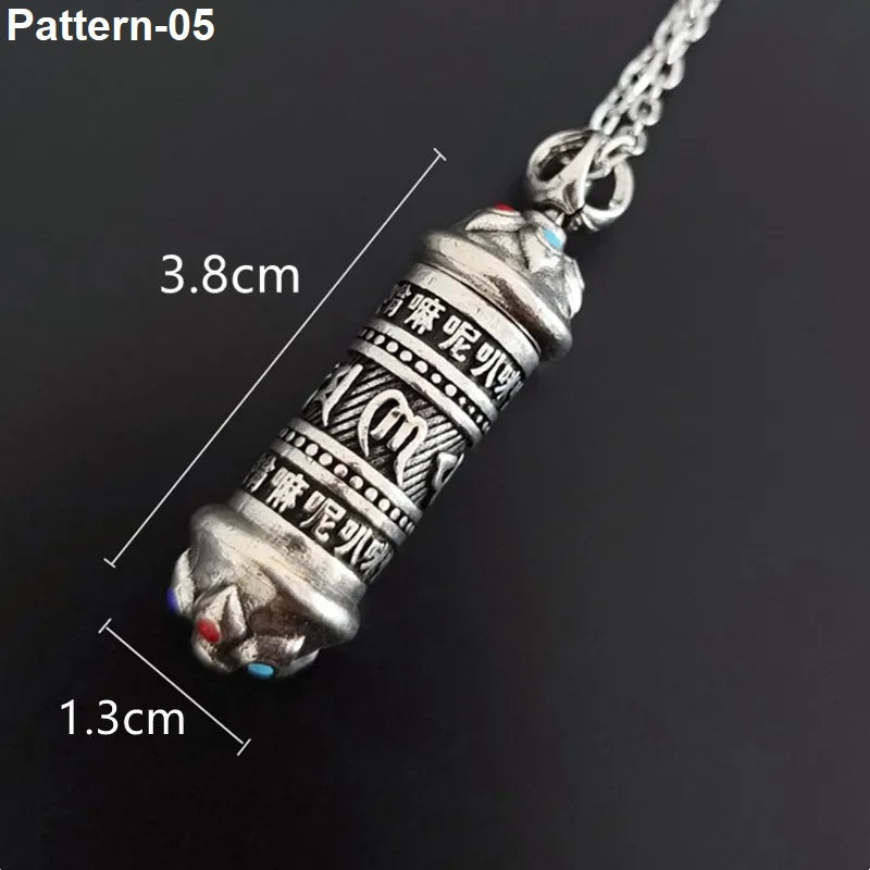 Silver pendant with measurements on a black background
