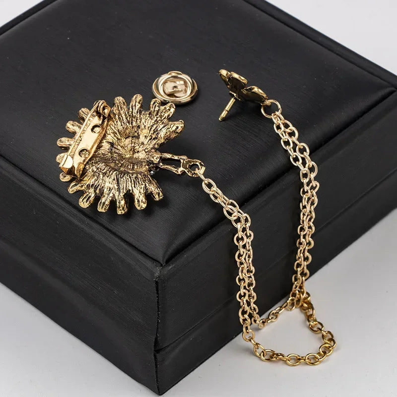 Gold brooch with chain premium fashion accessory displayed on black box