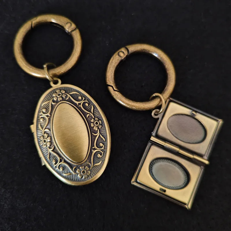 both show Vintage book and oval style photo locket keychain opened to show on dark background