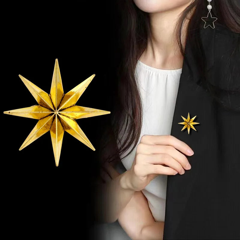 Woman wearing black blazer with gold star brooch pin accessory