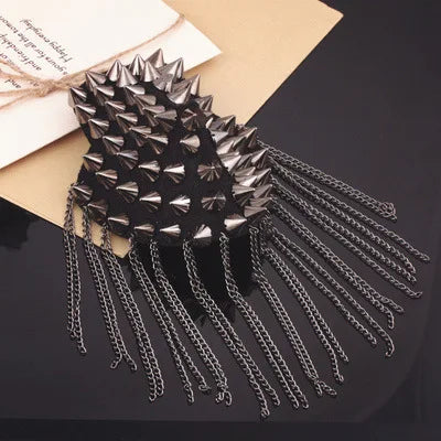 Black studded shoulder brooch with long chain tassels