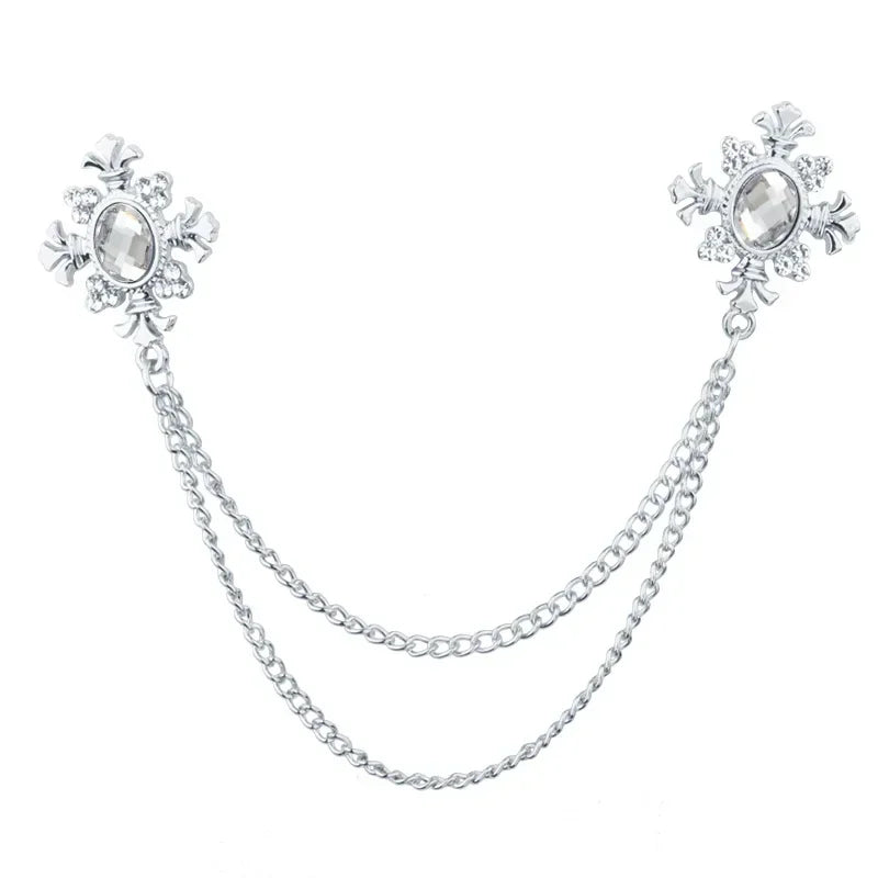 Silver White Crystal cross collar brooch with decorative chain design on white background.