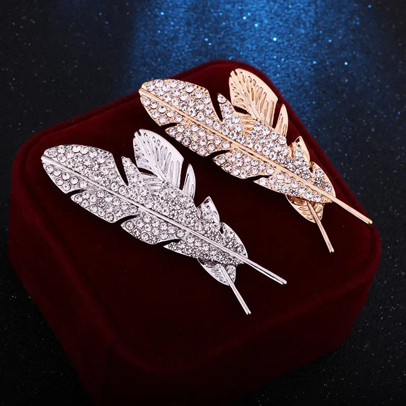 gold and silver feather lapel pin close up luxury men fashion jewelry