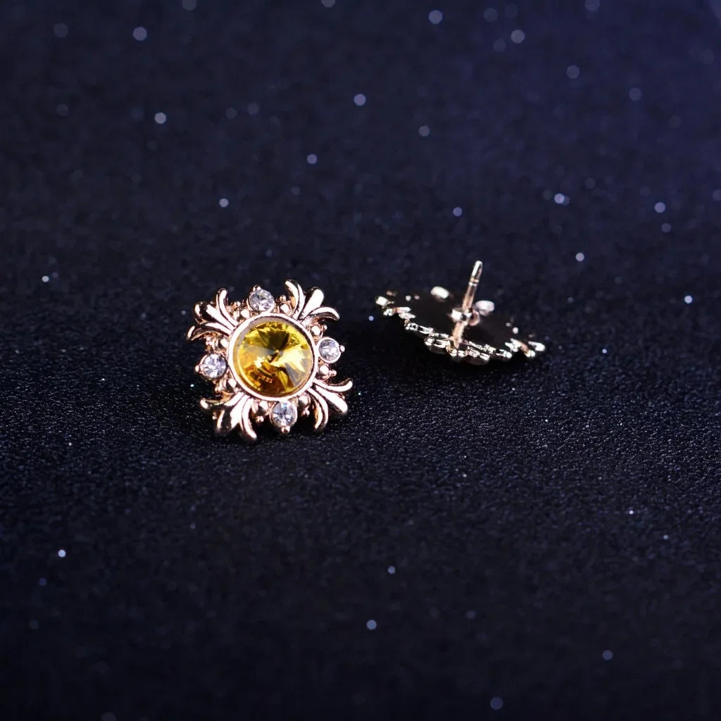 Gold brooch with yellow gemstones on a dark background