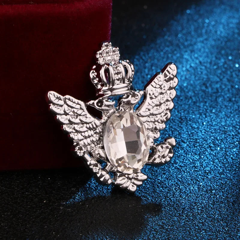 silver angel brooch with mirror gemstone luxury fashion jewelry on blue and red fabric background