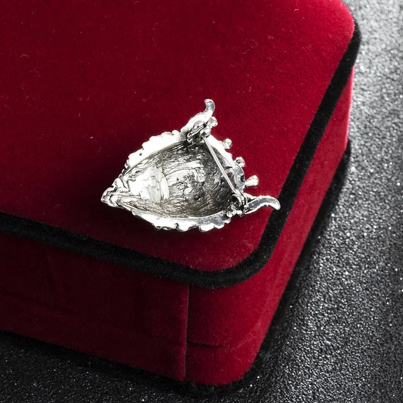 Back side view of silver lion head brooch metal finish and clasp detail fashion pin