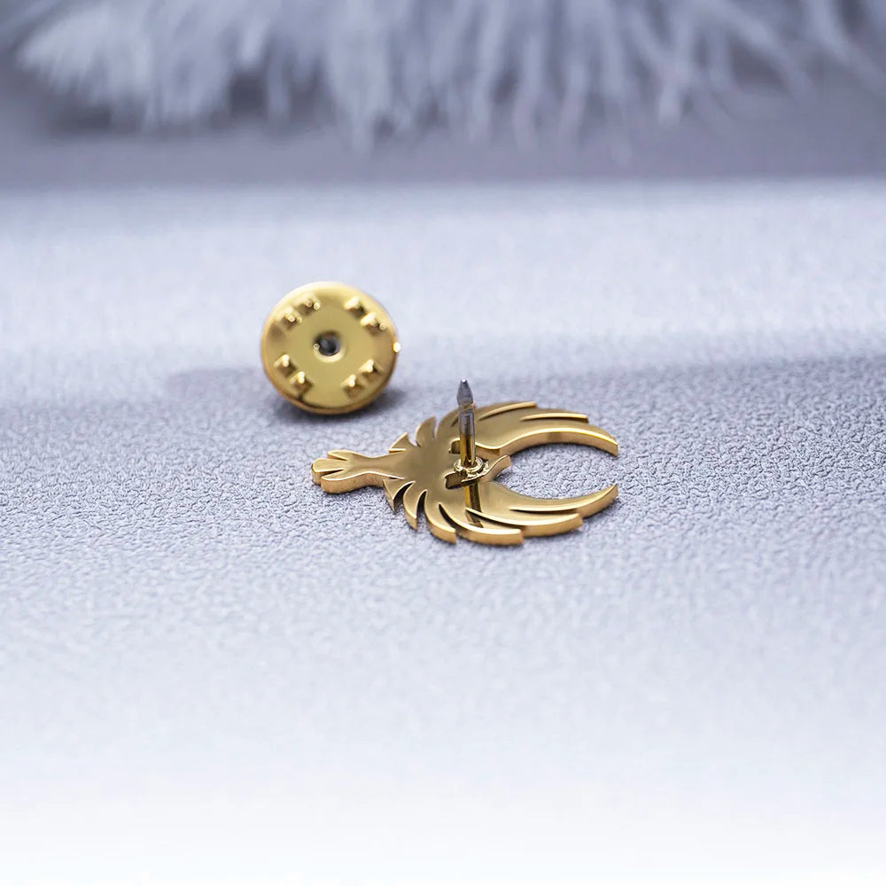 Gold earring fashion jewelry on textured surface with soft blurred background