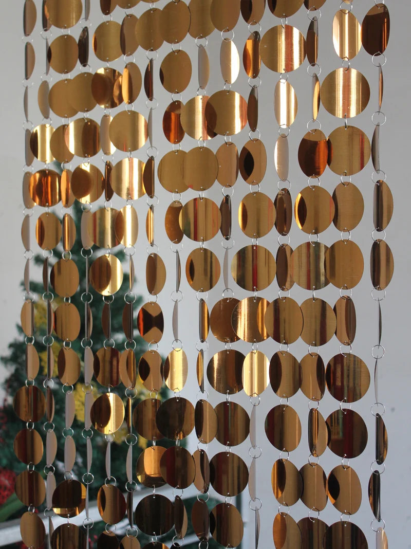 Gold circular mirror sequin panel on a white wall