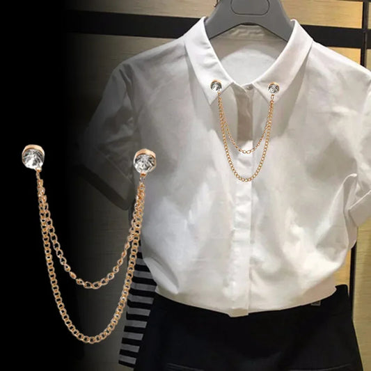 White shirt styled with gold double chain collar brooch accessory