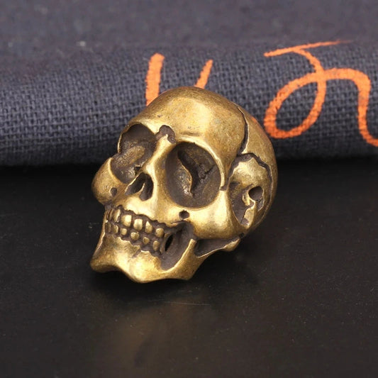 Solid brass skull head figurine with antique finish for gothic home decor, office desk decoration, and collectible display