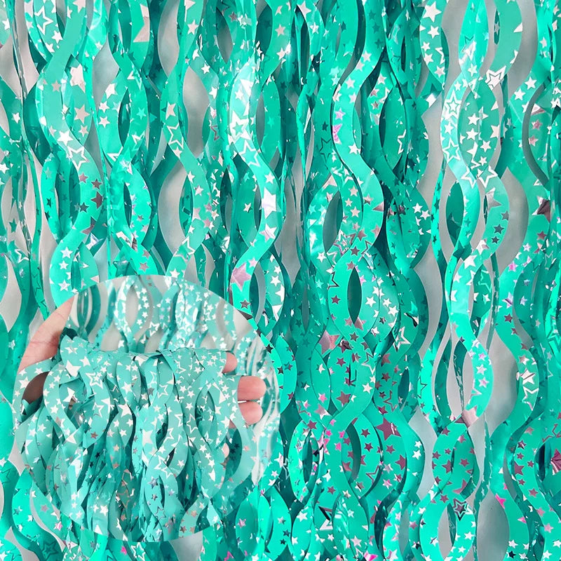 Turquoise metallic fringe curtain with star and heart accents for party decorations
