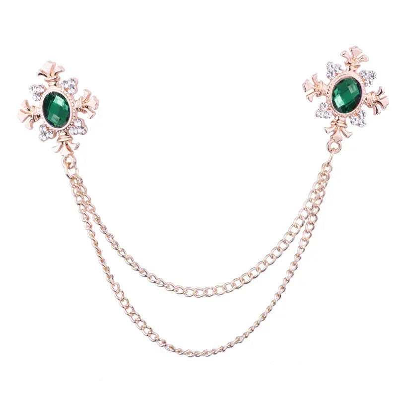 Gold Green Crystal cross chain brooch pins with gemstone accents on white background.