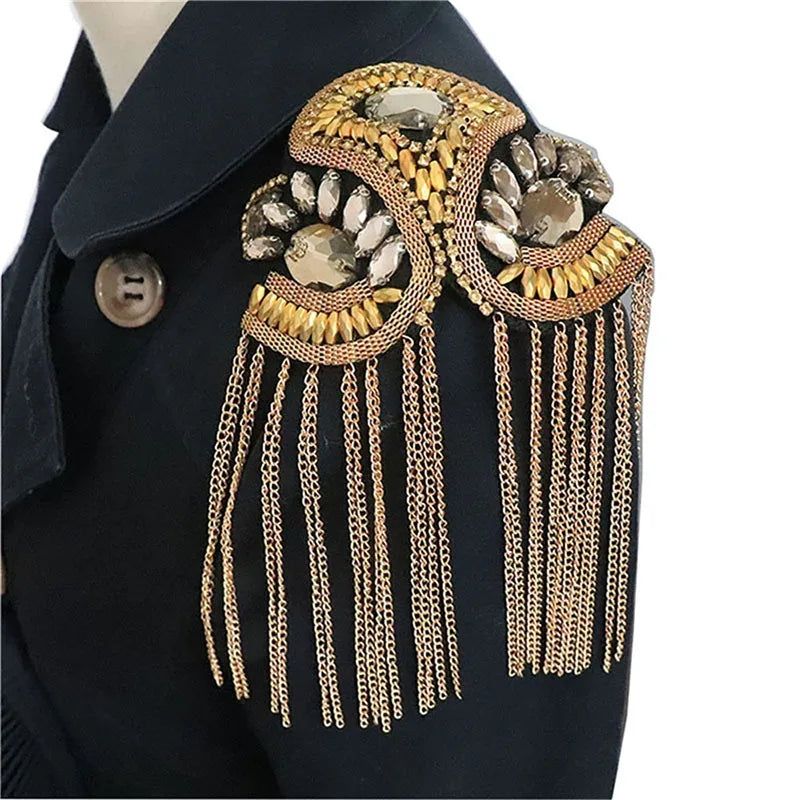 Luxury brooch with gold chains and rhinestone detailing on coat